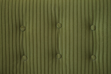 Close up of dark green fabric in fluted strips pattern. Seamless background texture. High quality...