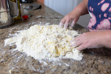 woman hands kneading dough on table