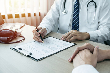 Doctor consulting with the patient and checking sickness condition while presenting results diagnosis symptom examining about the problem of illness and recommend treatment method