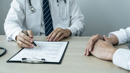 Doctor consulting with the patient and checking sickness condition while presenting results diagnosis symptom examining about the problem of illness and recommend treatment method