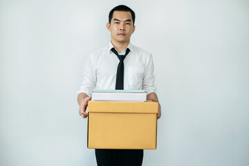 Business man employee carrying packed personal belongings in brown cardboard box and preparing to moving