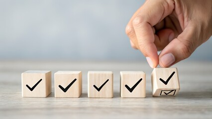 Hand placing a wooden block with a checkmark in a row of completed tasks