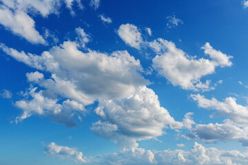 Cumulus clouds against blue sky. Concept of tranquility and solitude