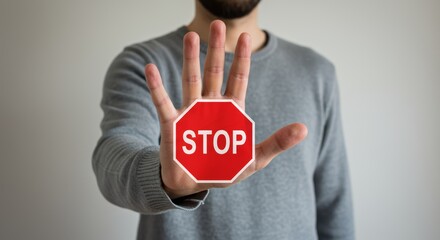Hand gesture with stop sign overlay communicating urgent message to halt or pause action