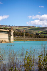 Obraz premium Los Bermejales Reservoir is a tranquil body of water surrounded by scenic natural landscapes and pine forests in the province of Granada, Spain