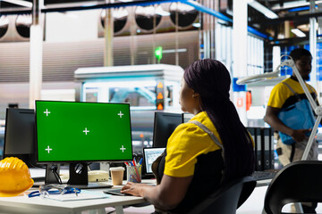Fototapeta premium Photovoltaics factory expert finetuning system settings on green screen PC. Employee works on laptop at the solar panels manufacturing plant for assembly lines configuration.