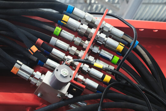 Bundle of pipes connected to industrial hydraulic pneumatic machine, industrial concept background