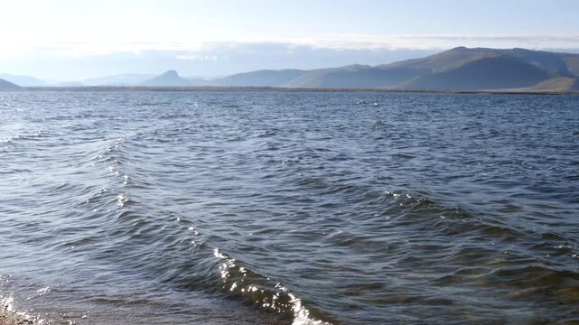 The beach of Terkhiin Tsagaan Nuur Lake under a cloudy sky on an autumn evening. Mongolian landscape. 