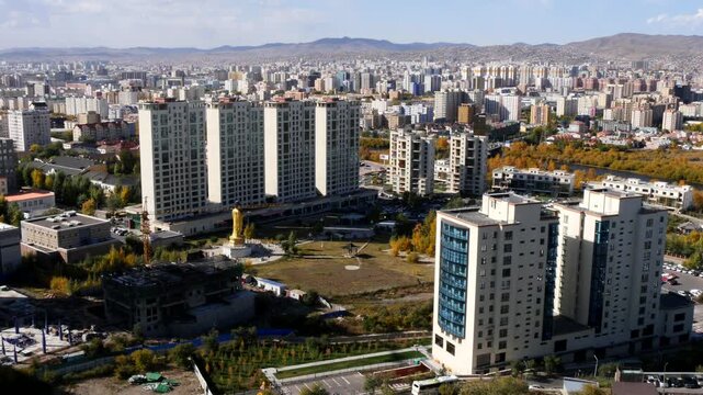 View of Ulaanbaatar from a high mountain on a sunny autumn day, Mongolia. The Buddha statue is visible in Buddha Park.