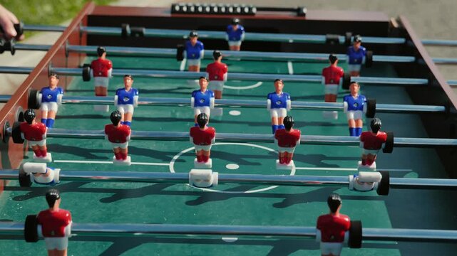 Table football game with red and blue players during a sports day