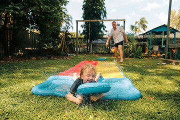 Summer backyard slip and slide family fun