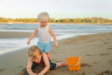 Little kids playing in the sand on the beach