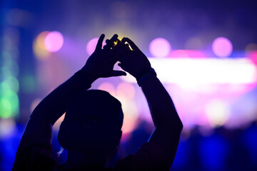 hands reaching for heaven praising Jesus during worship service