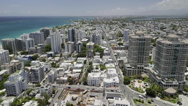 Drone flies east high over Condado neighborhood on sunny day in San Juan, Puerto Rico