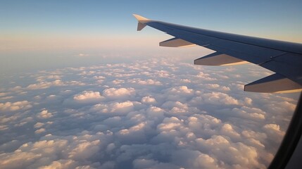 Captivating aerial view of clouds and sky from an airplane window, capturing a peaceful flight experience.