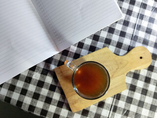 Cozy Tea Break Relaxation with a cup of tea by an open notebook