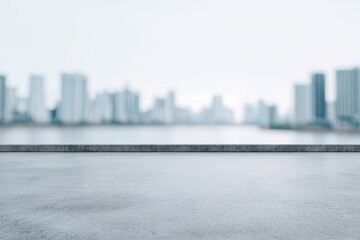 Obraz premium Empty concrete platform overlooking a blurred cityscape
