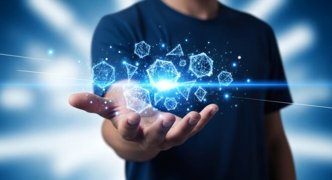 Hand holding glowing digital geometric shapes with blue light trails