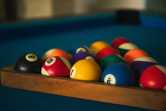 Colored billiard balls are arranged on a green table