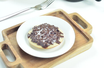 Serabi pancake with chocolate jam topping, a traditional Indonesian snack.