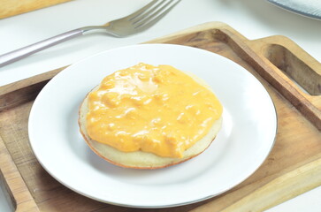 Serabi with cheese pasta topping, a traditional Indonesian snack.