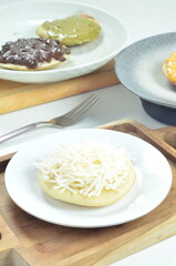 Serabi with grated cheese topping, a traditional Indonesian snack