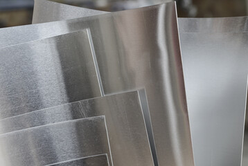close up of thin silver aluminum pieces with blurred background