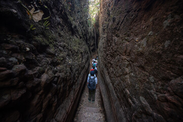 Tourist visiting the bizarre Naga Cave, located in the Bueng Kan province of Northeastern Thailand. This strange and amazing beauty of the large stone shaped like a giant snake.