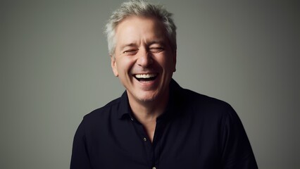 Obraz premium Joyful laughter of a middle-aged man in a studio setting portrait photography soft lighting happy vibes
