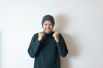 Indonesian man wearing winter clothes feels annoyed