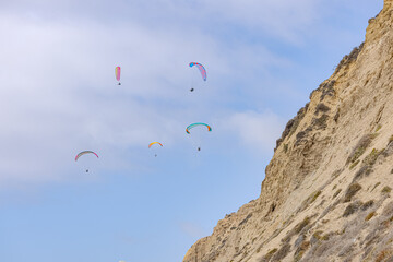 People paragliding over Black Beach La Jolla California 2025 