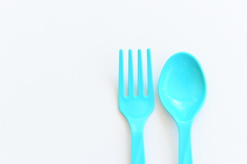 blue spoon and fork isolated on white background, plastic cutlery for picnic