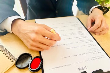 書類にハンコを押すビジネスマンの手元