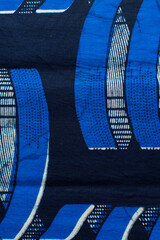 top view of blue and white ankara fabric, flatlay of nigerian wax cloth, overhead view of blue and...