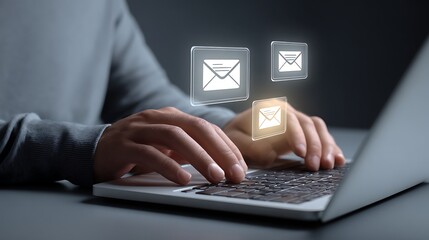 Hands typing on laptop with glowing email icons above