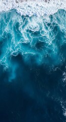 Naklejka premium A mesmerizing aerial view captures the dynamic contrast between foamy white ocean waves and the deep, tranquil blue water below.