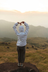 Lifestyle traveler happy feeling good relax and freedom facing in the sunrise morning. Travel Concept