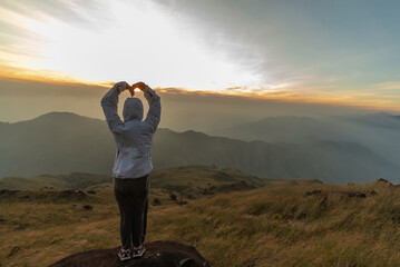 Lifestyle traveler happy feeling good relax and freedom facing in the sunrise morning. Travel Concept