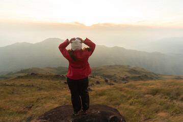 Lifestyle traveler happy feeling good relax and freedom facing in the sunrise morning. Travel Concept