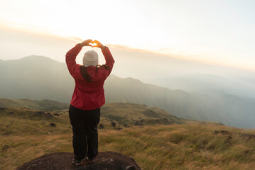 Lifestyle traveler happy feeling good relax and freedom facing in the sunrise morning. Travel Concept