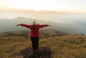 Lifestyle traveler happy feeling good relax and freedom facing in the sunrise morning. Travel Concept