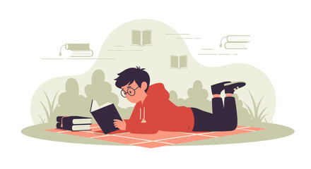 Fototapeta premium Young man engrossed in reading a book outdoors on a patterned blanket for leisure