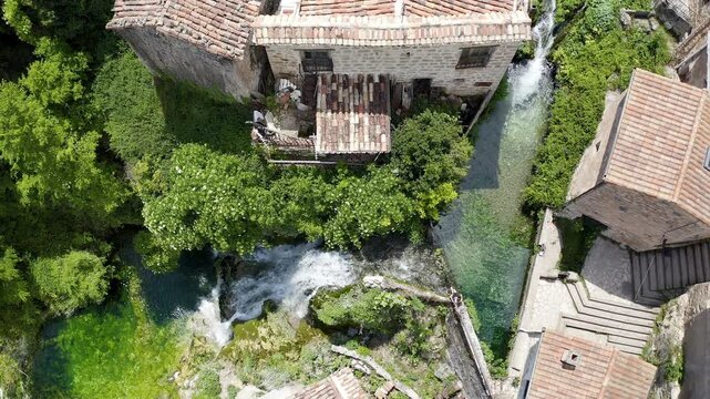 Aerial view of little town and the beautiful waterfall of Orbaneja del Castillo in Burgos, Spain.
