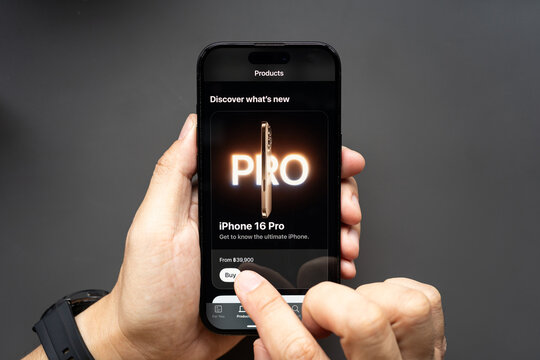 Hand Holding Smartphone Displaying "iPhone 16 Pro" Product Page. the essence of technology, consumerism, and the anticipation of new product releases.