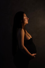 Obraz premium young pregnant woman in black dress