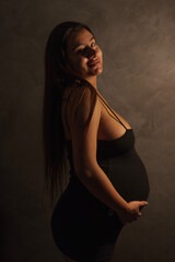 young pregnant woman in black dress