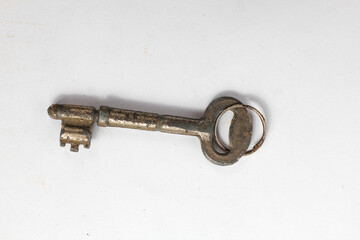 rusty house key isolated white background.