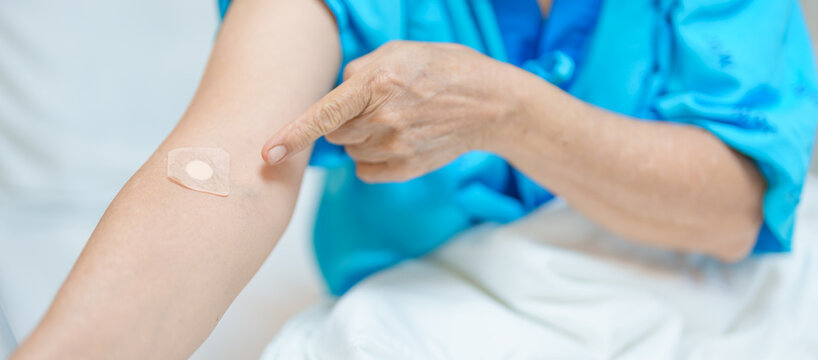 Elderly asian Patient Woman with medical patch plaster after blood test in hospital. Diagnose, illness, treatment, Insurance, Healthcare, medical Examination, Blood donation and World Blood Donor Day