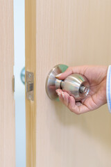 Woman hand holding doorknob and Open door. close the door knob