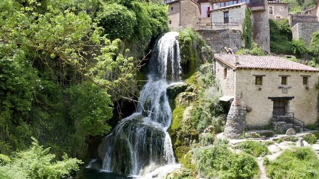 Aerial view of little town and the beautiful waterfall of Orbaneja del Castillo in Burgos, Spain.